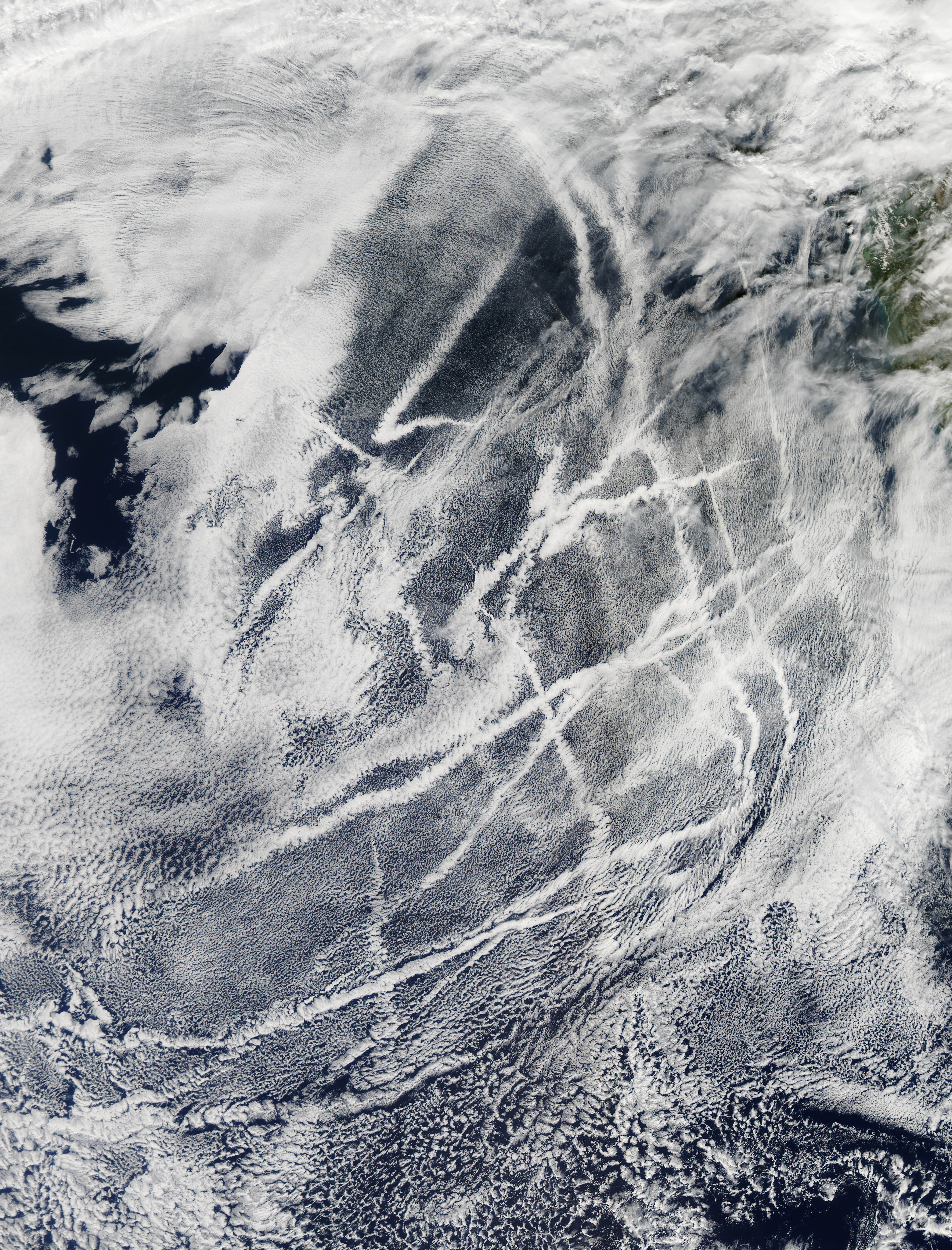 Multiple ship tracks visible from space off the California coast in the Pacific Ocean, creating parallel cloud formations
